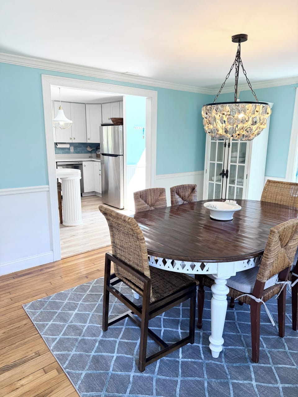 Kitchen into dining area for 6 w/ unique oyster chandelier 