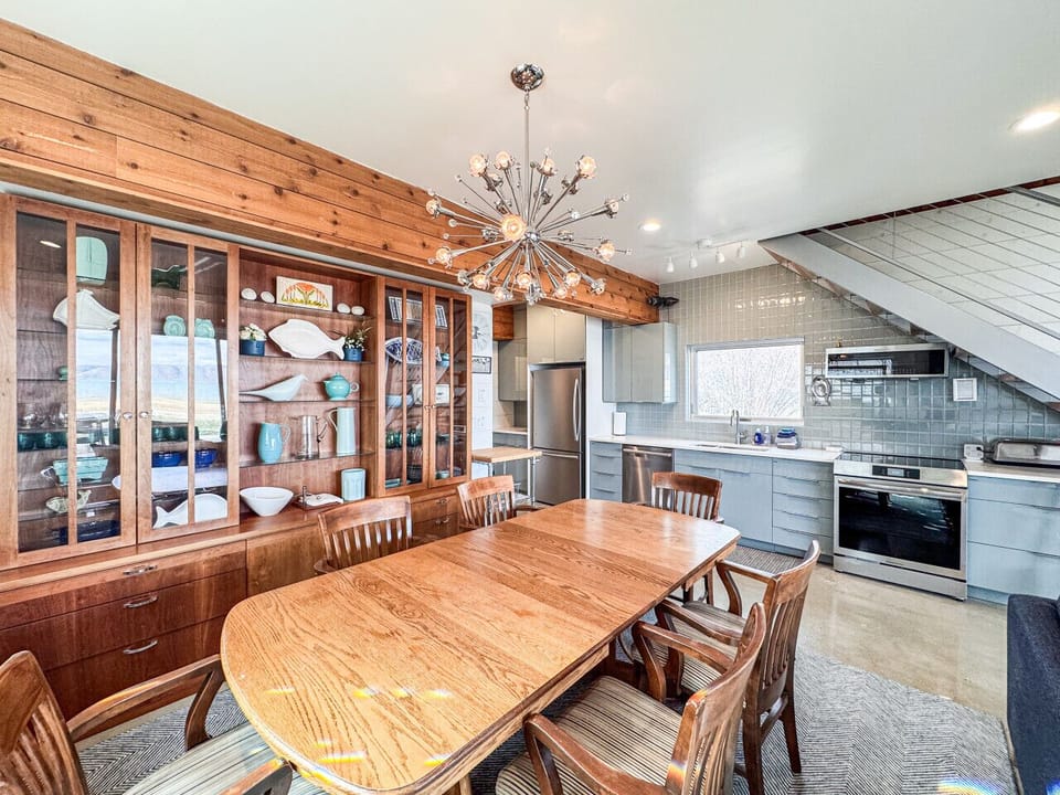 Warm, stylish dining space with custom woodwork, statement lighting, and inviting open layout