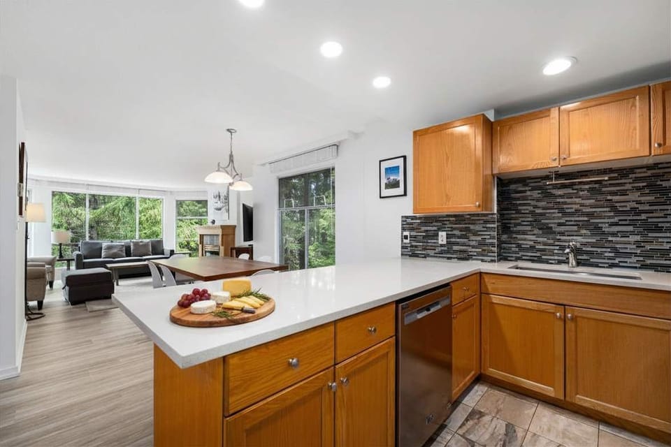 - Open-concept kitchen and dining area perfect for shared gatherings - Modern lighting and sleek finishes create a warm inviting flow - Ideal setup for family meals or group get-togethers after mountain fun