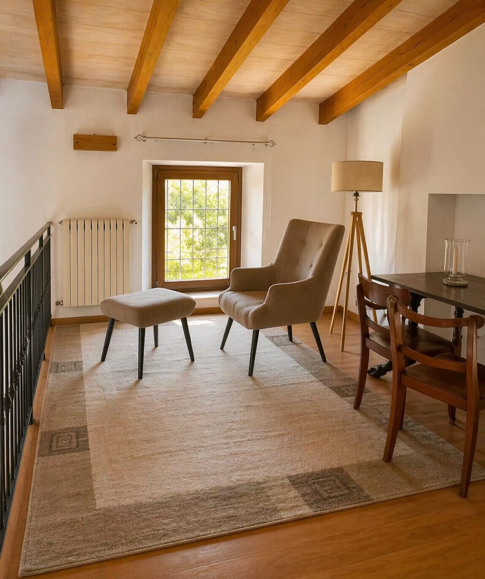 Reading area with armchair, footrest and natural light in finca in Pollensa