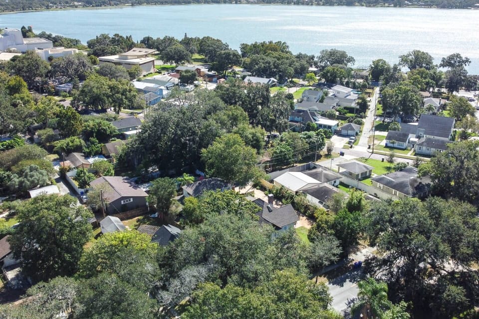 Aerial view highlighting the home’s prime location near the water, surrounded by quiet streets and charming homes—close to local attractions.