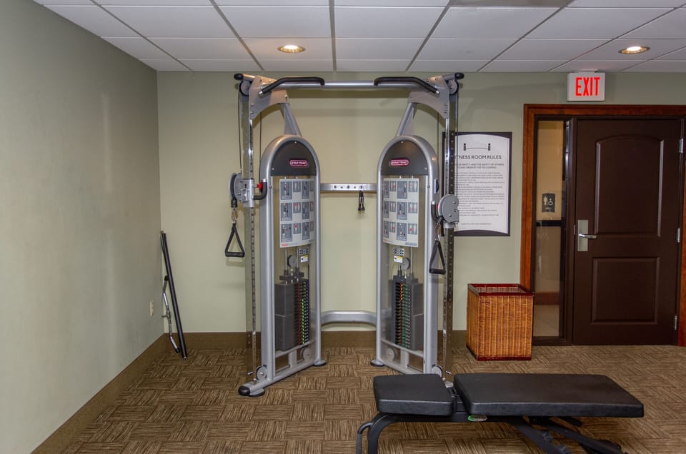 Strength training area complete with weight machines and instructional signage.