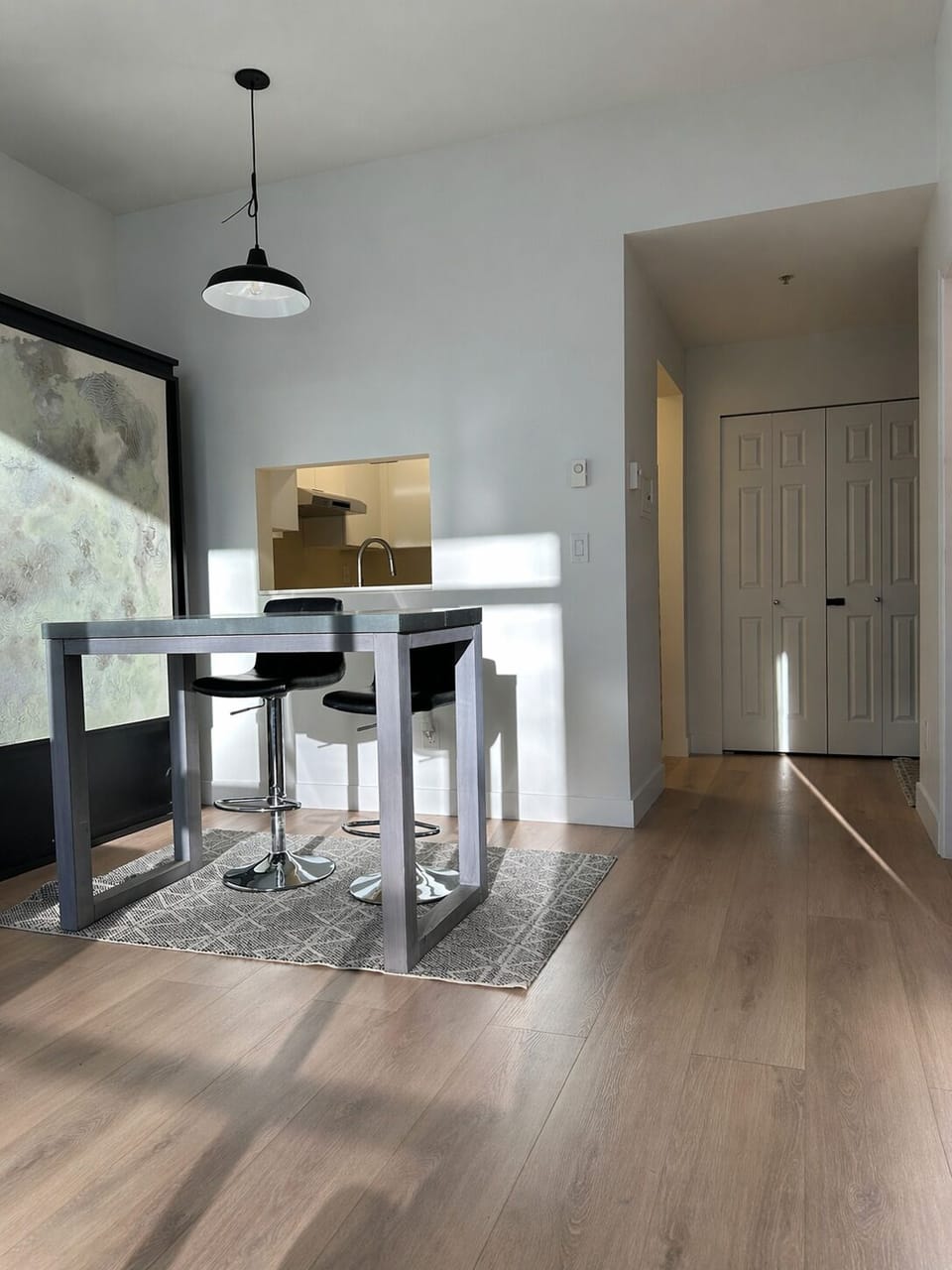 Clean, modern dining zone: high-top table, sleek lines, and open flow 