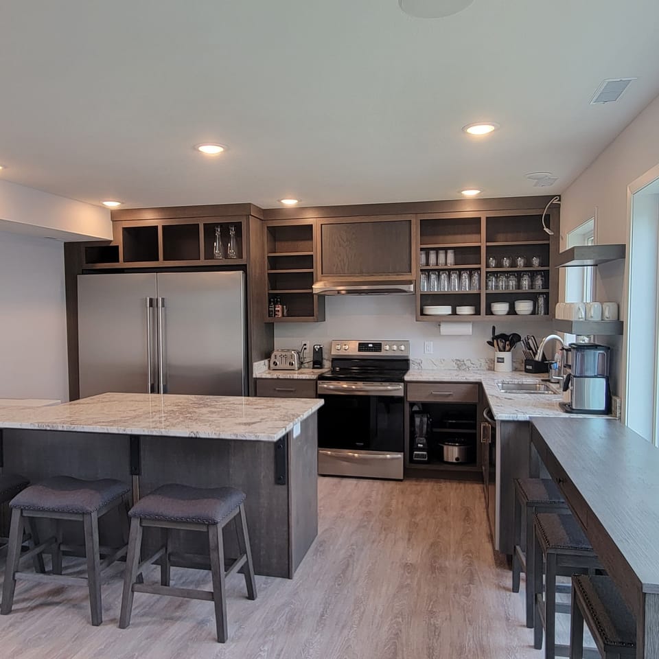 Fully stocked kitchen with double subzero refrigerator and granite counter tops.