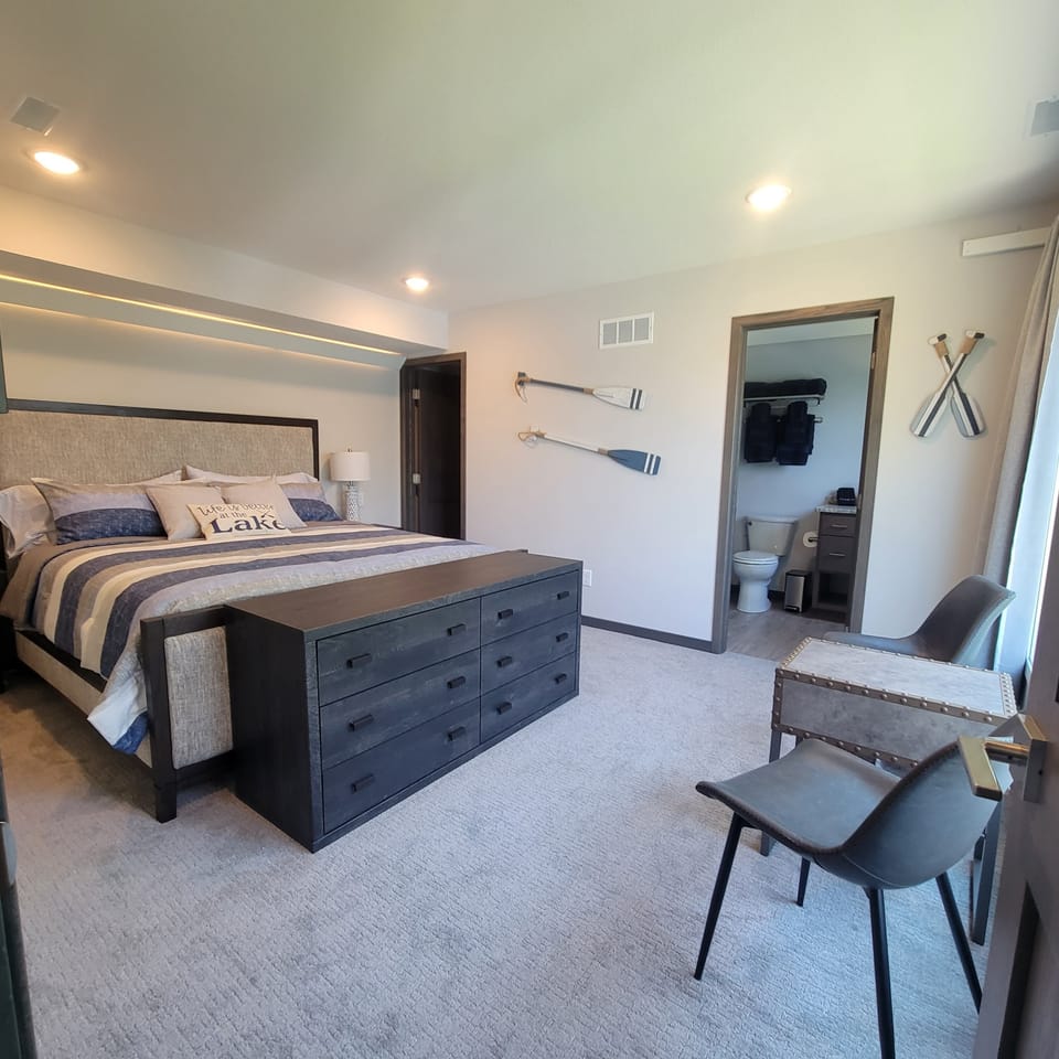 King bedroom with walk-in closet, full bathroom and lake views