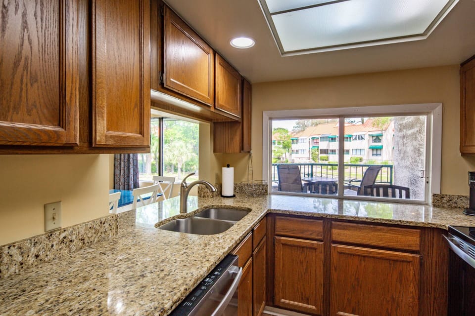 The kitchen features a dishwasher and ample counter space for preparing your meals.