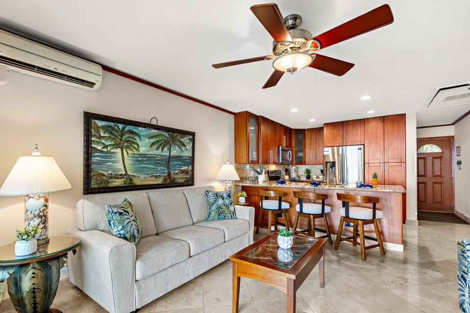 Spacious living room flowing into a fully equipped kitchen—perfect for relaxing or entertaining.