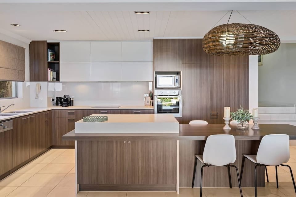 Fully equipped modern kitchen with Nespresso coffee machine.