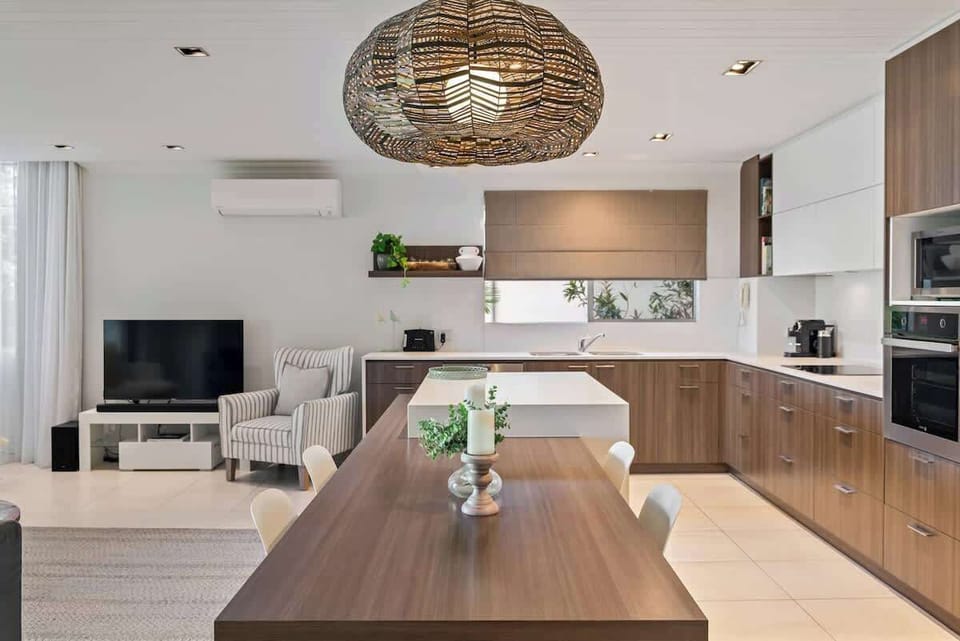 Fully equipped kitchen with all appliances and dining table to gather around.