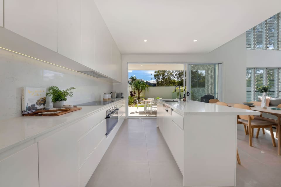 Fully equipped kitchen with stone benchtops and generous workspace