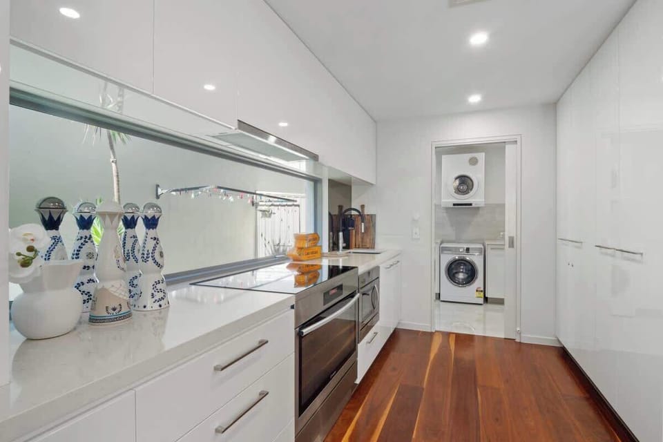 Fully equipped kitchen with stainless steel appliances, and separate Laundry.