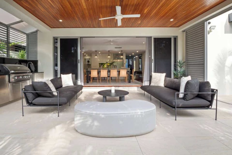 A stunning covered alfresco area overlooking flowing from the living space, complete with a built-in outdoor BBQ, perfect for entertaining - with waterfront views.