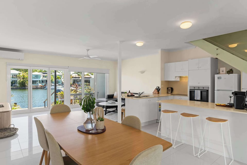 The dining area offers a bright, inviting space where you can share relaxed meals beside the open-plan kitchen and enjoy an easy flow to the waterfront patio.