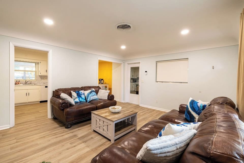 The door with the mirror opens to the garage. The laundry room will be on your right as you enter the garage. The garage door opener is on the right side of the door frame.