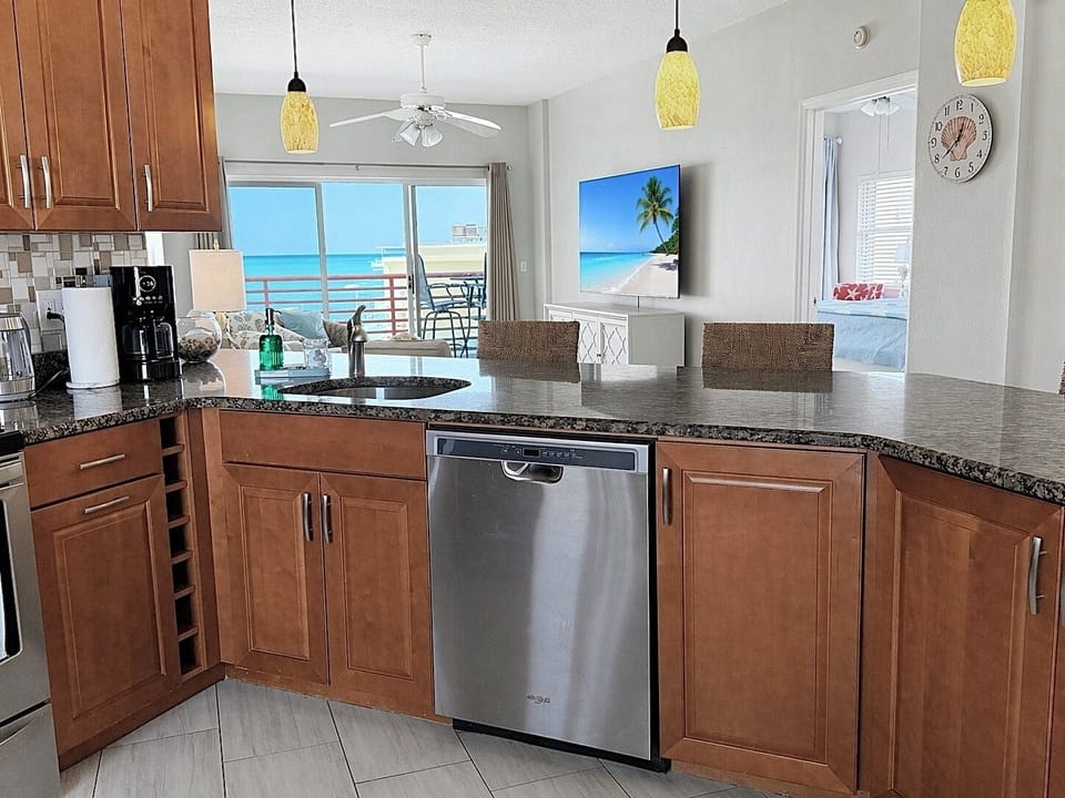 Fully equipped kitchen with bar seating & gulf view.