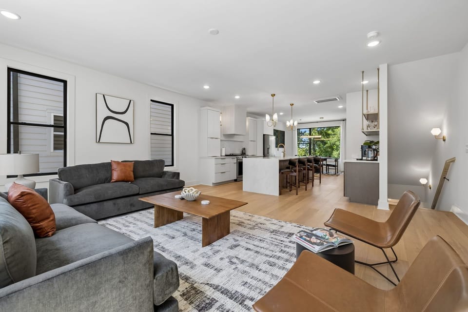 Living Room: The heart of the home — a warm, inviting living room with a fireplace, Smart TV, and sofa seating perfect for unwinding between Nashville adventures.