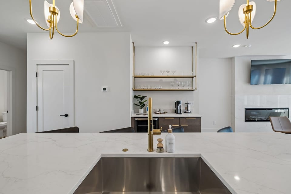 Kitchen: Skip the reservations — the gourmet kitchen is fully equipped with premium appliances, a spacious island, and every coffee option imaginable to start your morning right.
