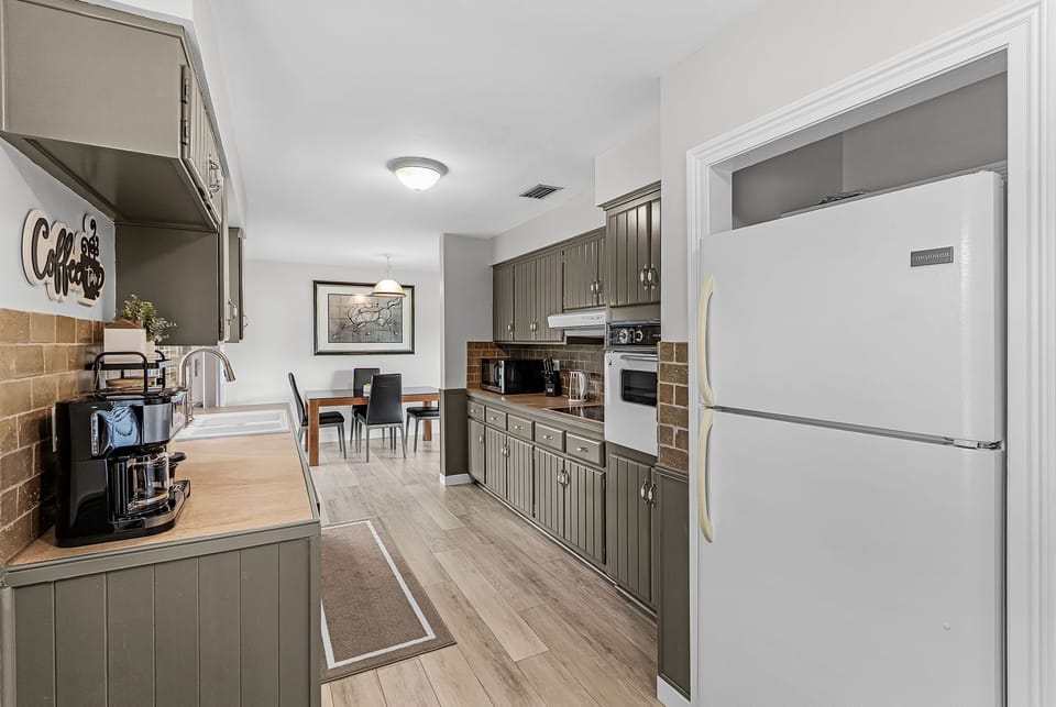 Modern cabinetry and a farmhouse-style sink.