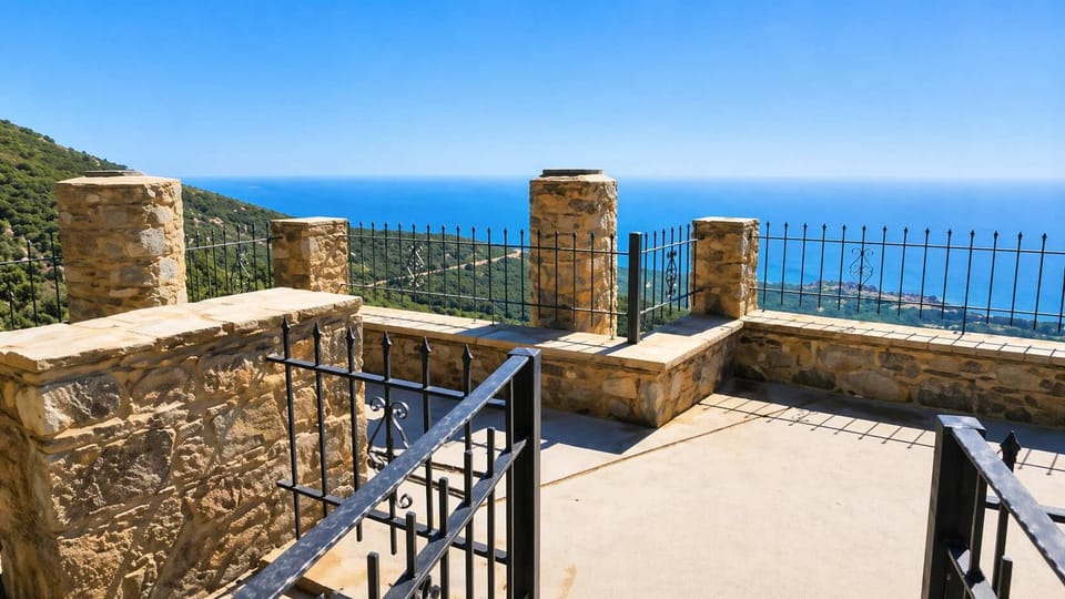 Panoramic sea-view terrace with traditional stone architecture.