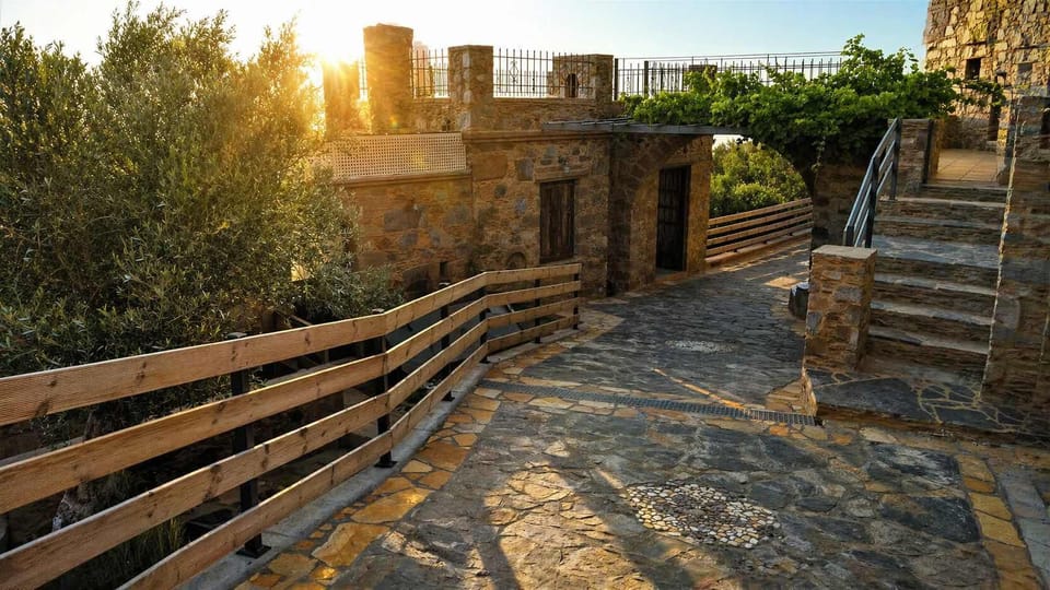 Stone pathway terrace with sunset views and wooden railing.