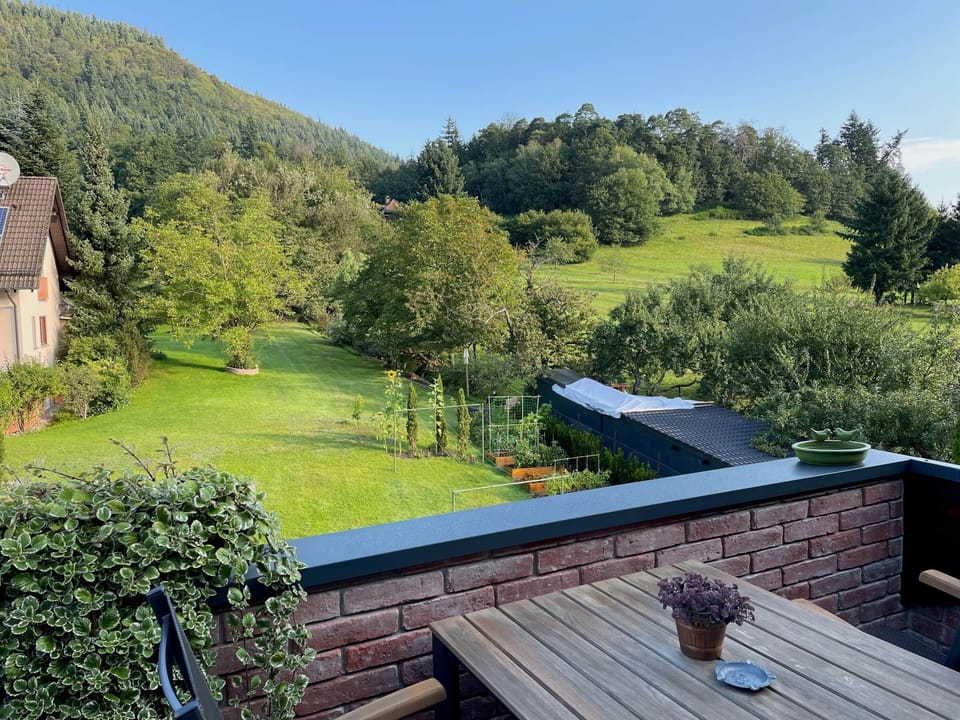 Generous views of the back garden as well the the immediately neighboring forest.