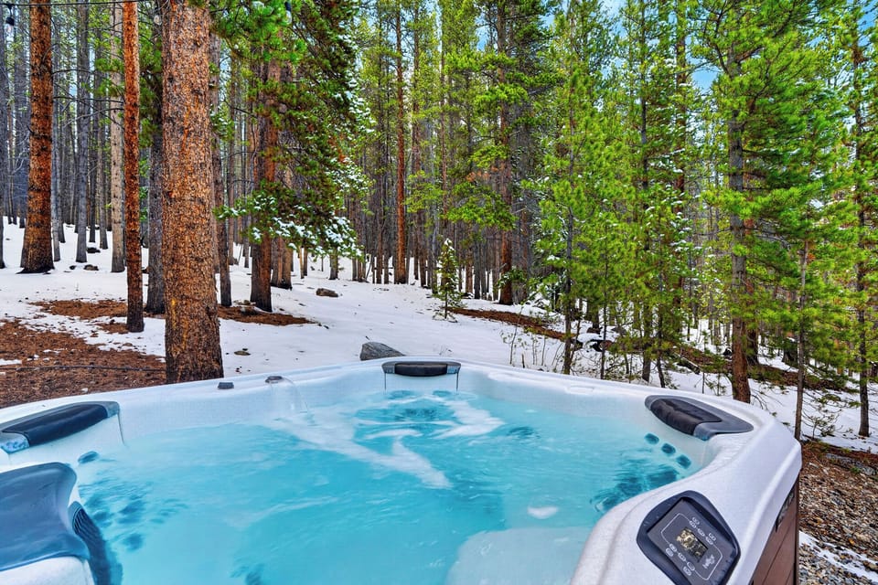 Private hot tub nestled in the trees—soak and unwind with peaceful forest views year-round.