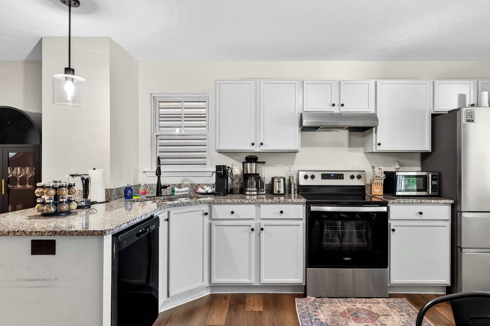 Kitchen: Bright and welcoming, this kitchen features updated appliances, functional space, and all the essentials for cooking, dining, and gathering together.