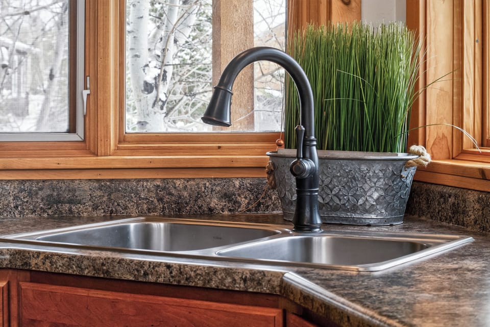 Prepare your favorite meals in 21 GCR 4435 with this beautifully appointed kitchen with granite countertops and charming winter views through the windows.