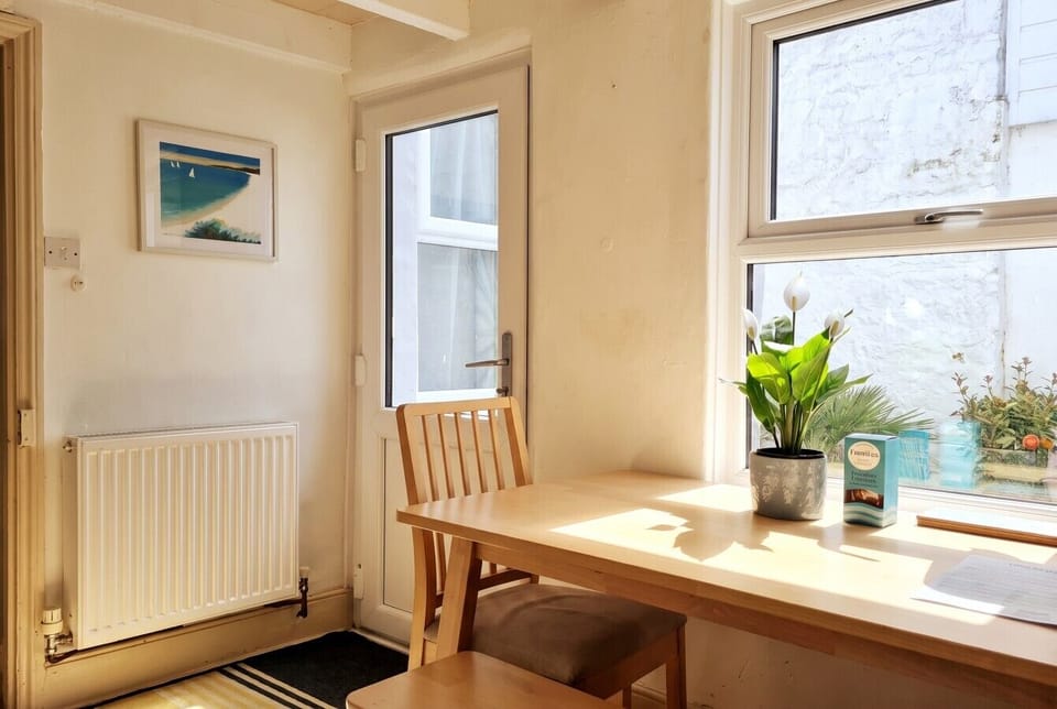 Sunlit desk nook by the courtyard door for coffee or catching up.