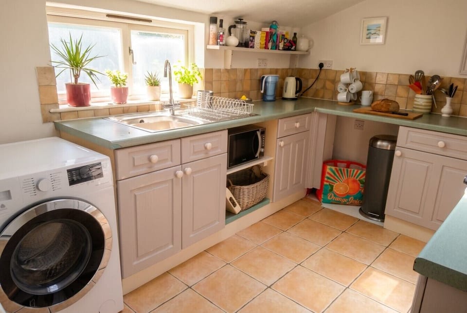 Well-equipped kitchen with dishwasher space and everyday essentials to hand.