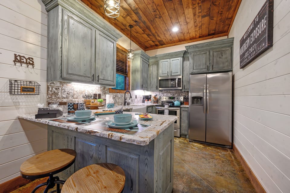 Your fully equipped kitchen features granite counters and rustic charm, perfect for preparing memorable meals together.