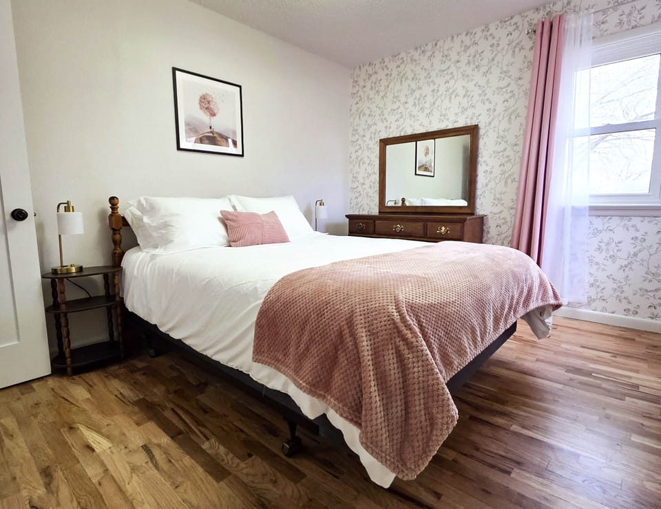 Queen bedroom with closet and dresser space, luggage rack