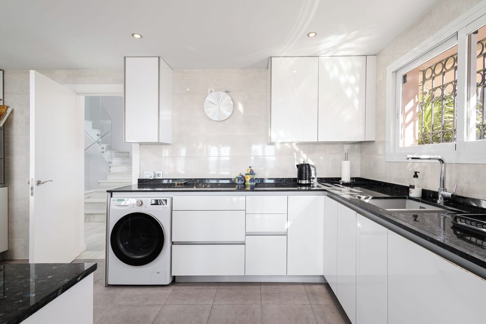 Modern, fully-equipped kitchen with high-end appliances & laundry facilities.