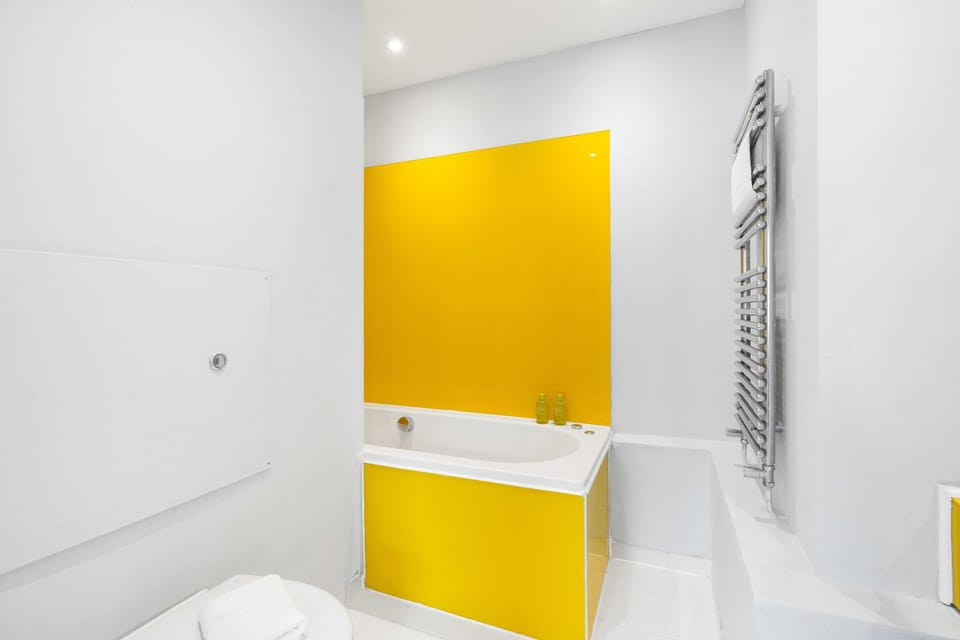 Bathroom with classic basin, mirror and toilet in neat holiday home setting