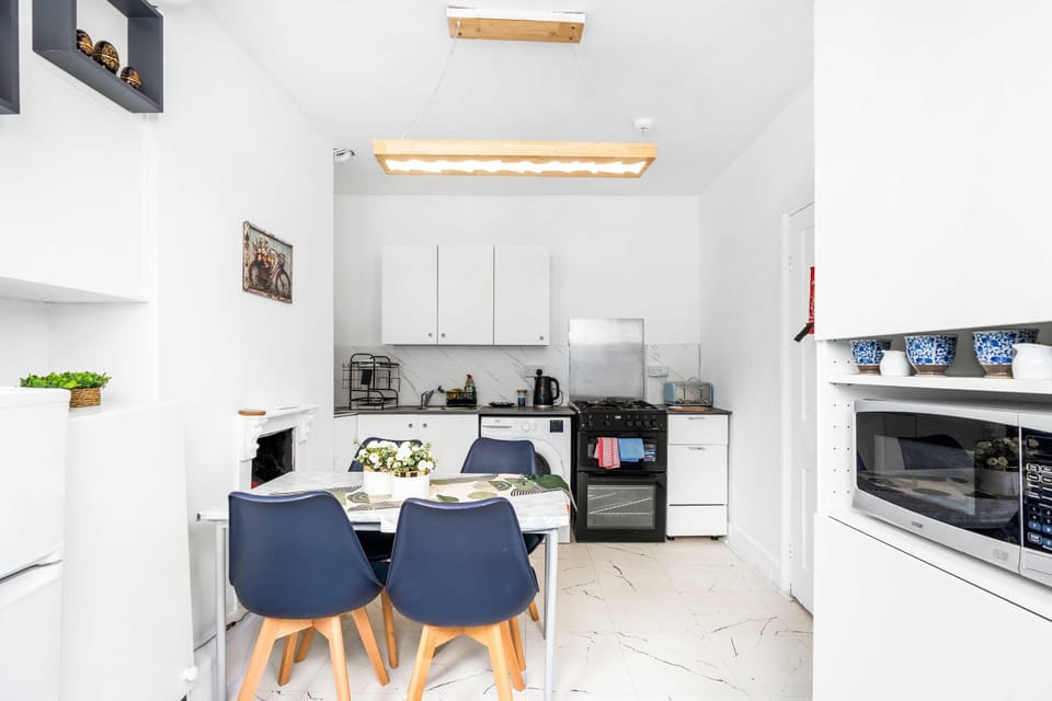 Fully equipped kitchen with modern appliances and dining space for guests