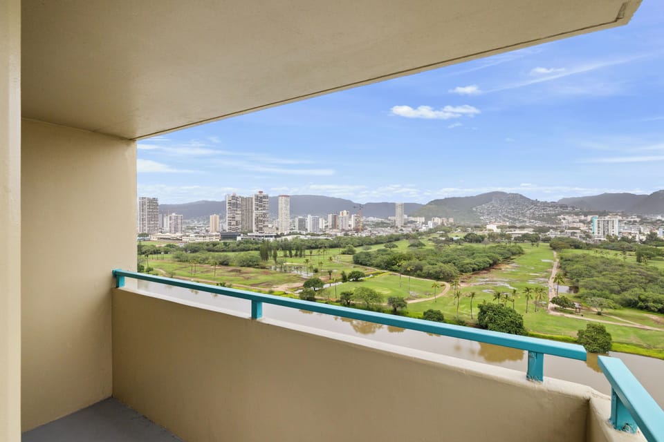 Wake up to panoramic views of the lush golf course and city skyline from your private balcony.