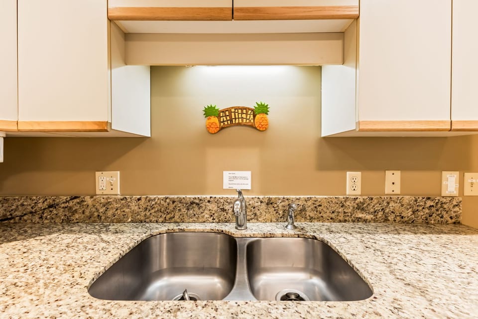Spacious granite countertops and a welcoming double sink make meal prep a breeze in your fully equipped kitchen.