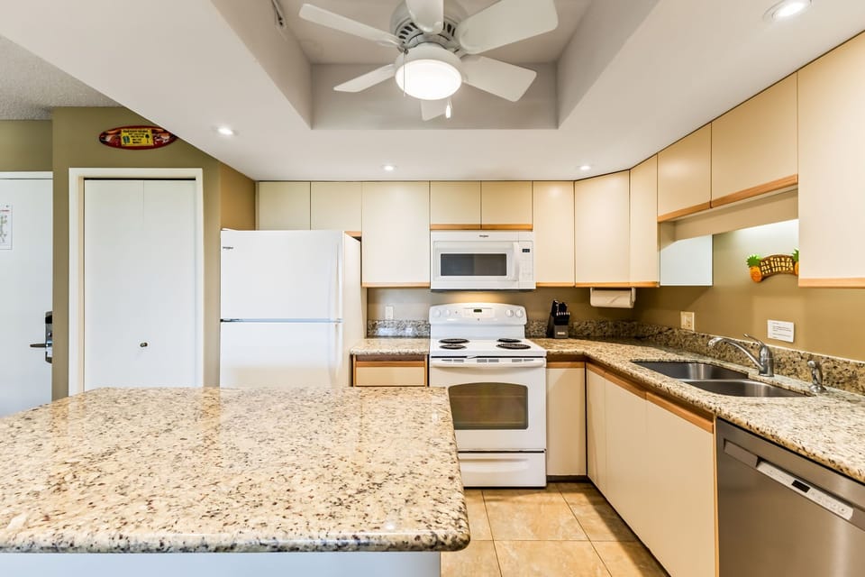 Your fully equipped kitchen awaits with modern appliances, ample counter space, and bright overhead lighting—perfect for preparing memorable meals during your stay.
