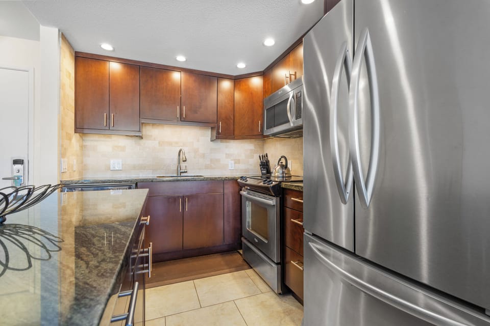 Your gourmet kitchen features granite countertops, rich wood cabinets, and premium stainless steel appliances for effortless meal preparation.