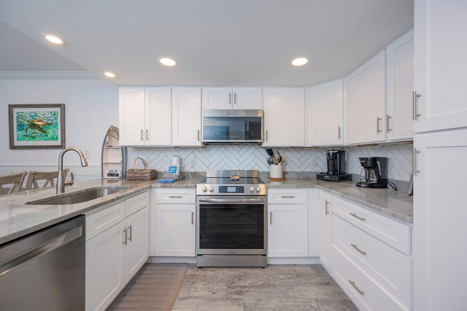 Stainless steel appliances and granite counters invite you to craft delicious meals in the kitchen