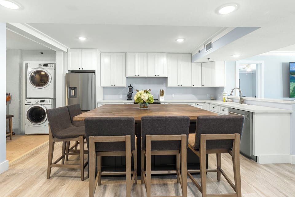 Cook and gather around your spacious kitchen island with modern appliances and convenient laundry access.
