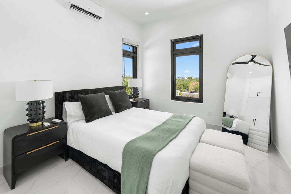 Enjoy a restful stay in this bright queen bedroom downstairs.