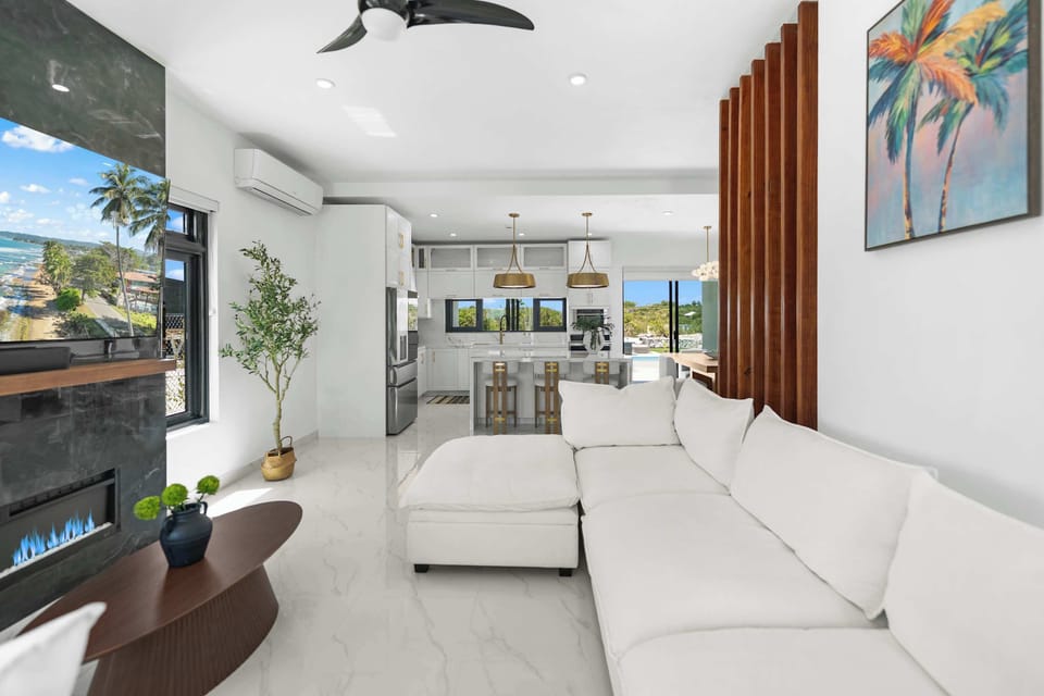 Sink into the plush white sofa for ultimate relaxation.