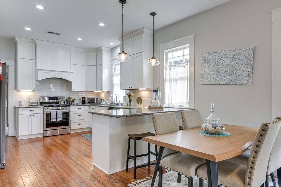 Open space with seating, full kitchen, and dining for six.