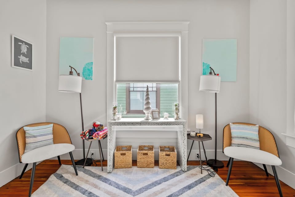 Reading nook with cozy chairs, soft lighting, and décor.