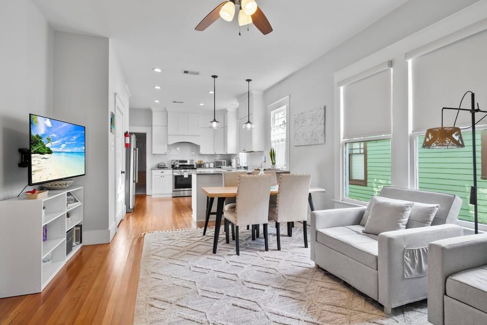 Bright open living with seating, kitchen, and dining for six.