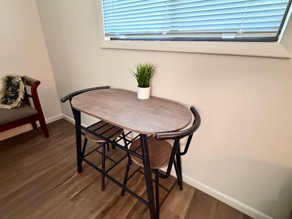 Bistro seating for two by the window in The Garden Room — coffee in the morning, wine after a day at the Lake Erie islands.