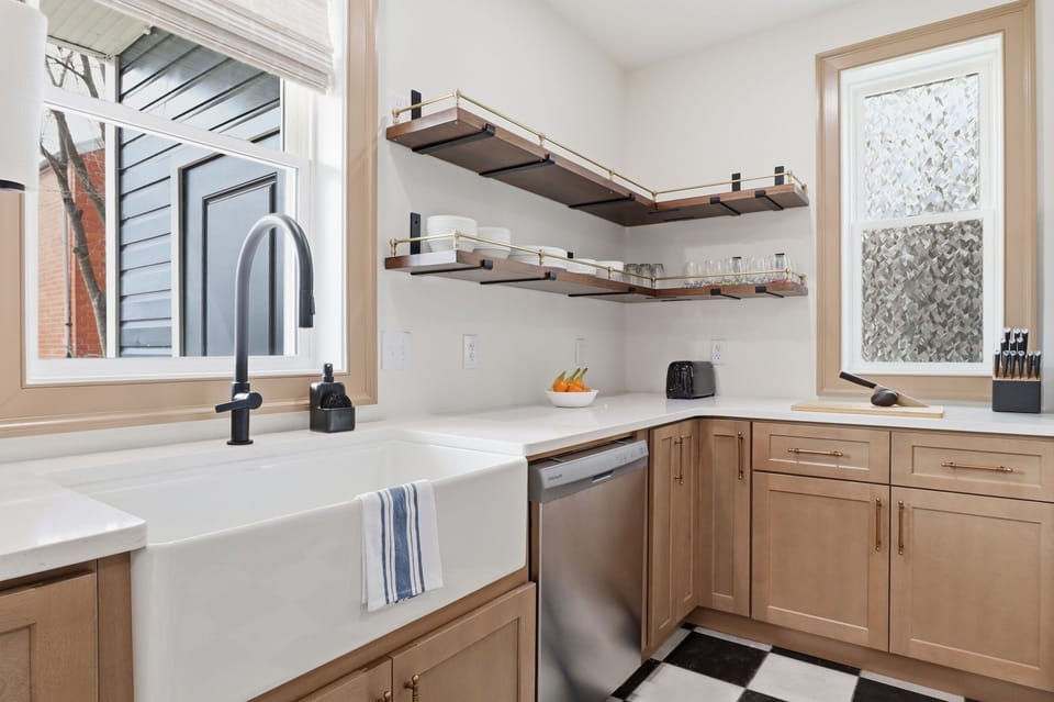 The walnut open shelving, brass hardware, and deep farmhouse sink are the kind of details you notice on day one and appreciate every day after. Everything you need to cook for a crowd is right here.