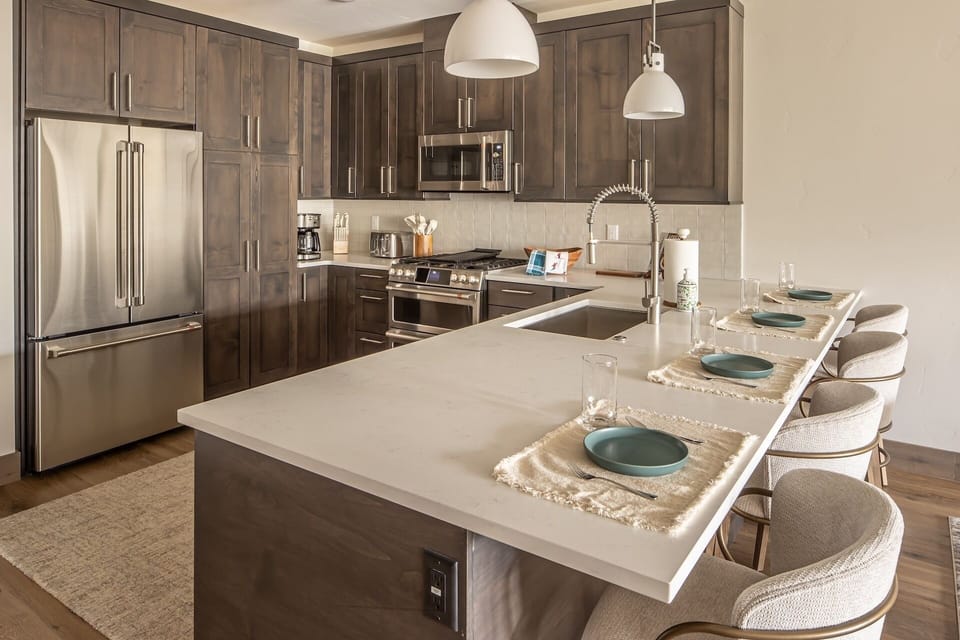 Your gourmet kitchen awaits with premium stainless steel appliances, elegant quartz countertops, and a breakfast island perfect for morning coffee.
