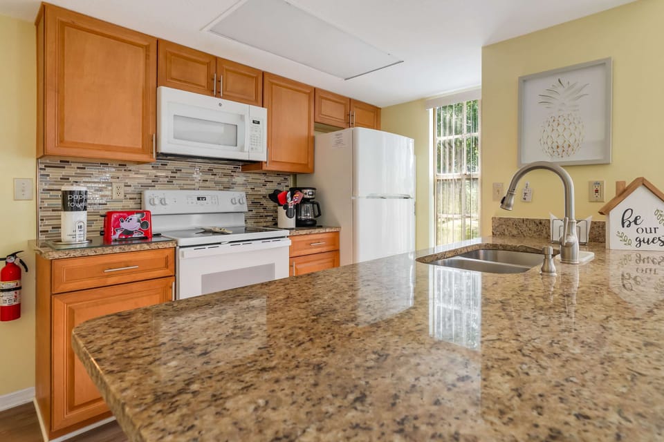 Modern kitchen with granite countertops and natural light from a large window